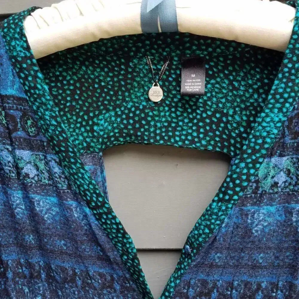 BKE Black Blue Green Top with a cut out in the back size Medium